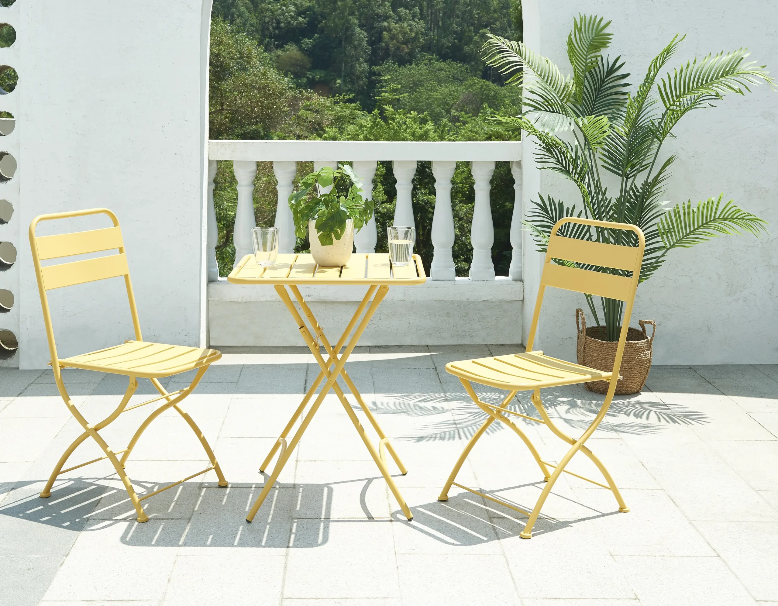 Yellow folding metal outdoor table and chairs on a patio