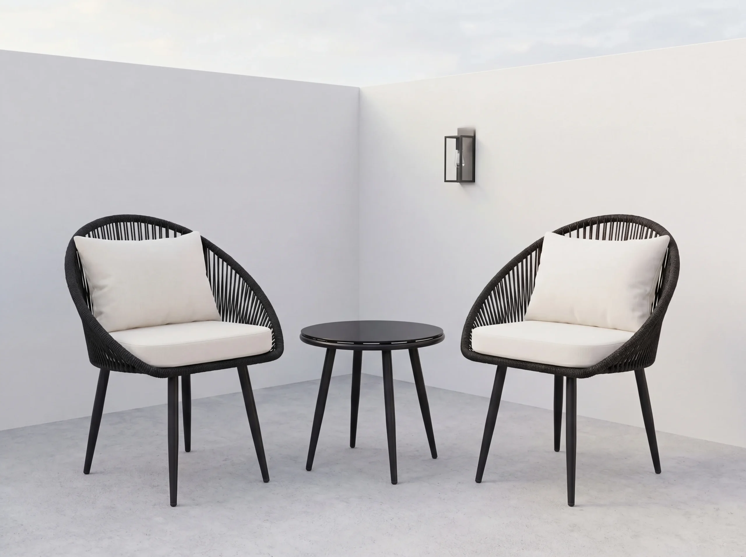 Black egg-shaped woven rope outdoor lounge chairs with white cushions